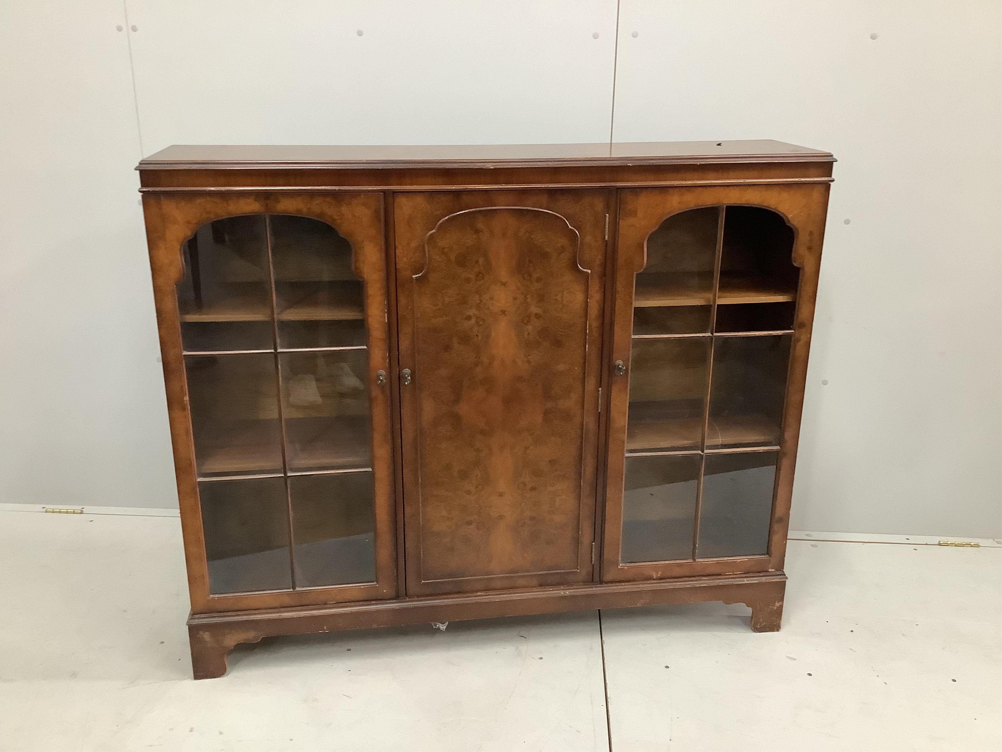 A Queen Anne Revival walnut bookcase, width 133cm, depth 30cm, height 109cm. Condition - poor